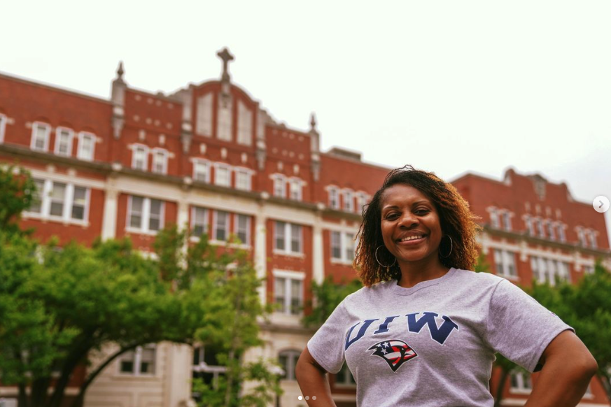 University of Incarnate word student smiling in front of research building